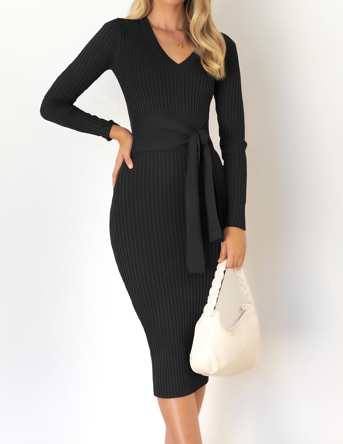 The Knit Sweater Dress in black — three-quarter view